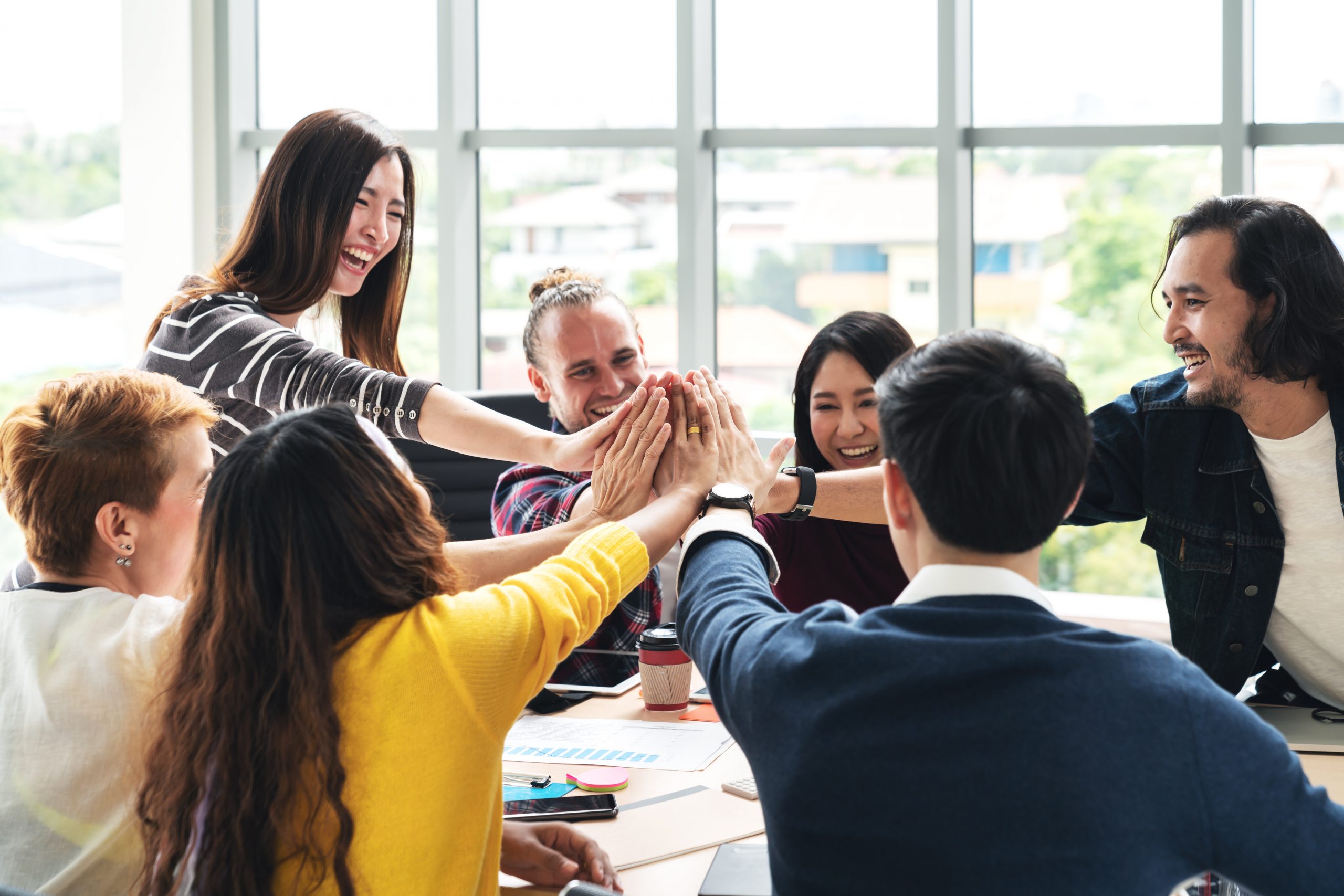 People celebrating teamwork in office | Menopause Friendly Workplace