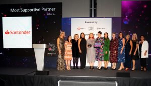 The Santander UK team on stage with Louise Minchin after winning The Most Supportive Partner Award 2022