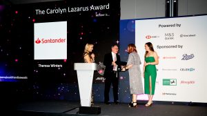 Theresa Winters of Santander on stage with Marc Lazarus, Daisy Lazarus and Louise Minchin after winning The Carolyn Lazarus Award 2022