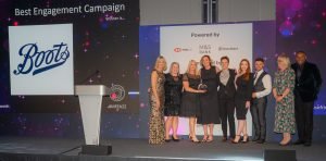 The Boots Team on stage with Louise Minchin receiving the Best Engagement Campaign Award at The Menopause Friendly Employer Awards 2022