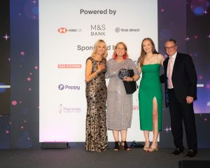 Theresa Winters of Santander UK, winner of The Carolyn Lazarus Award on stage with Louise Minchin, Daisy Lazarus and Marc Lazarus at The Menopause Friendly Employer Awards 2022
