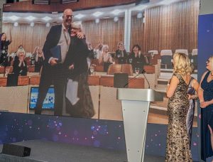 Mandy Baughurst of Leicestershire County Council, winner of The Community Award on stage with Louise Minchin at The Menopause Friendly Employer Awards 2022