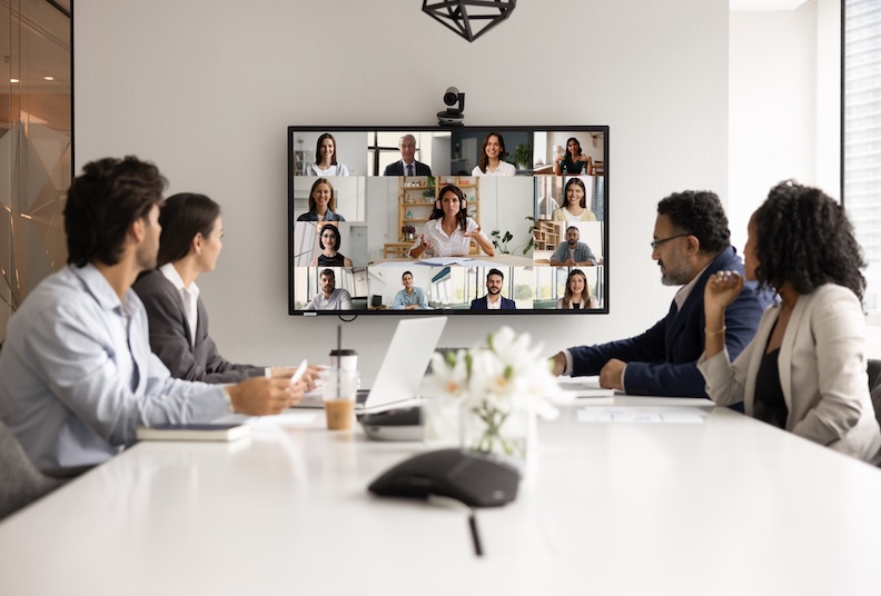 Diverse colleagues collaborating in a hybrid workplace meeting, reflecting global efforts to improve menopause support at work.